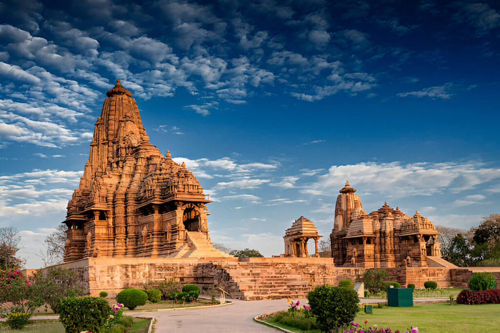 Beautiful image of Kandariya Mahadeva temple, Khajuraho, Madhyapradesh, India with blue sky and fluffy clouds in the background, It is worldwide famous ancient temples in India, UNESCO world heritage site.