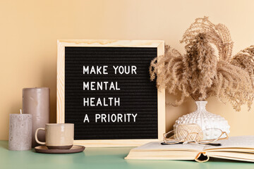 Make your mental health a priority motivational quote on the letter board. Inspiration psycological text