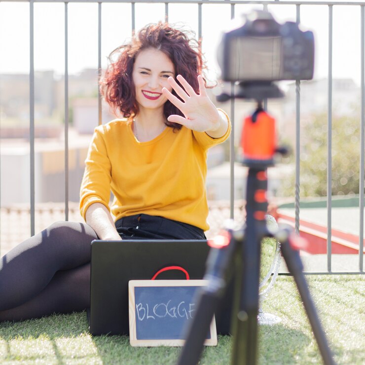 Brunette blogger showing blackboard to the camera